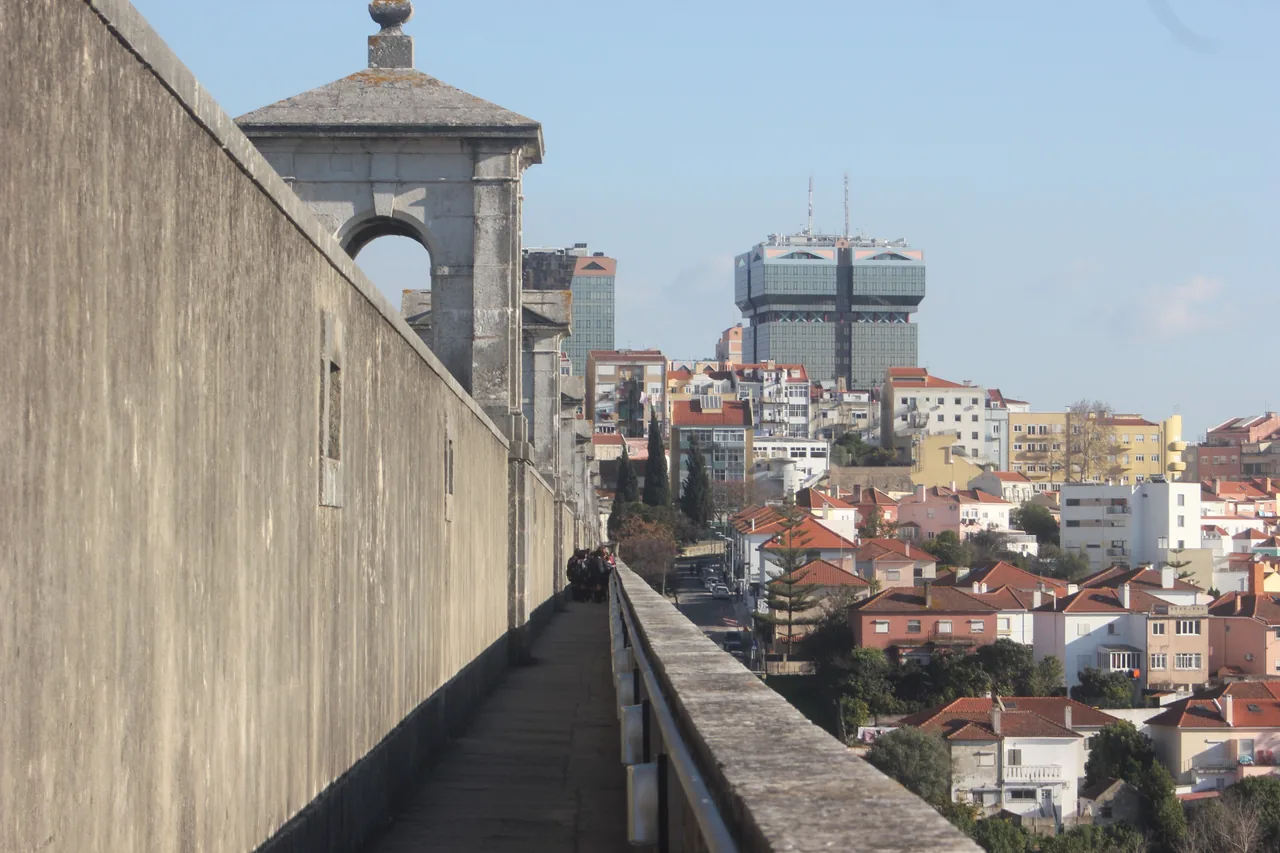 Walkway along the aqueduct with Lisbon’s buildings below