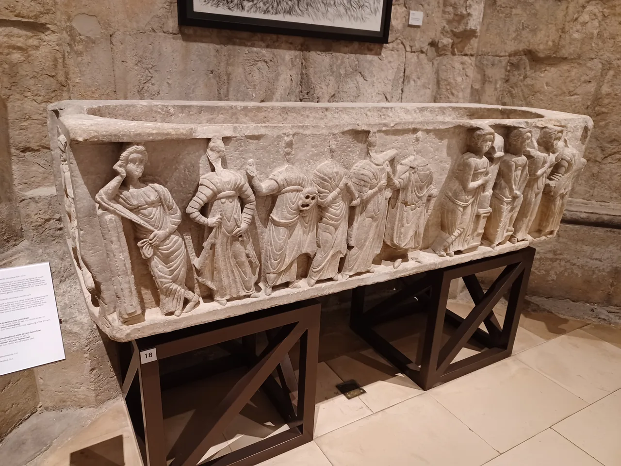 A Roman sarcophagus decorated with a row of carved figures in Carmo Archaeological Museum.