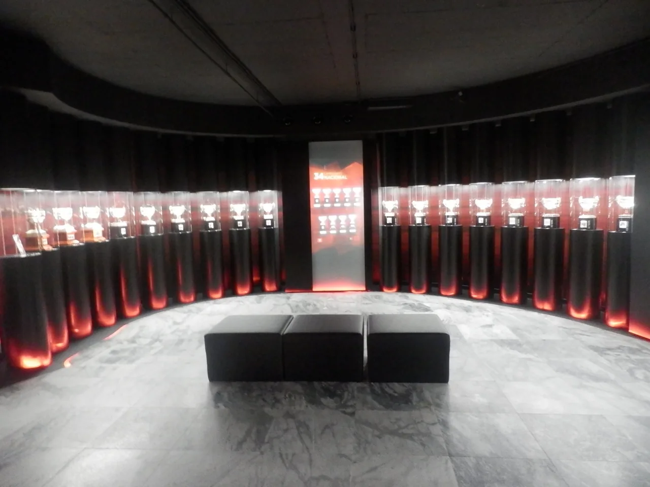 A curved display of league trophies in the Benfica Museum.