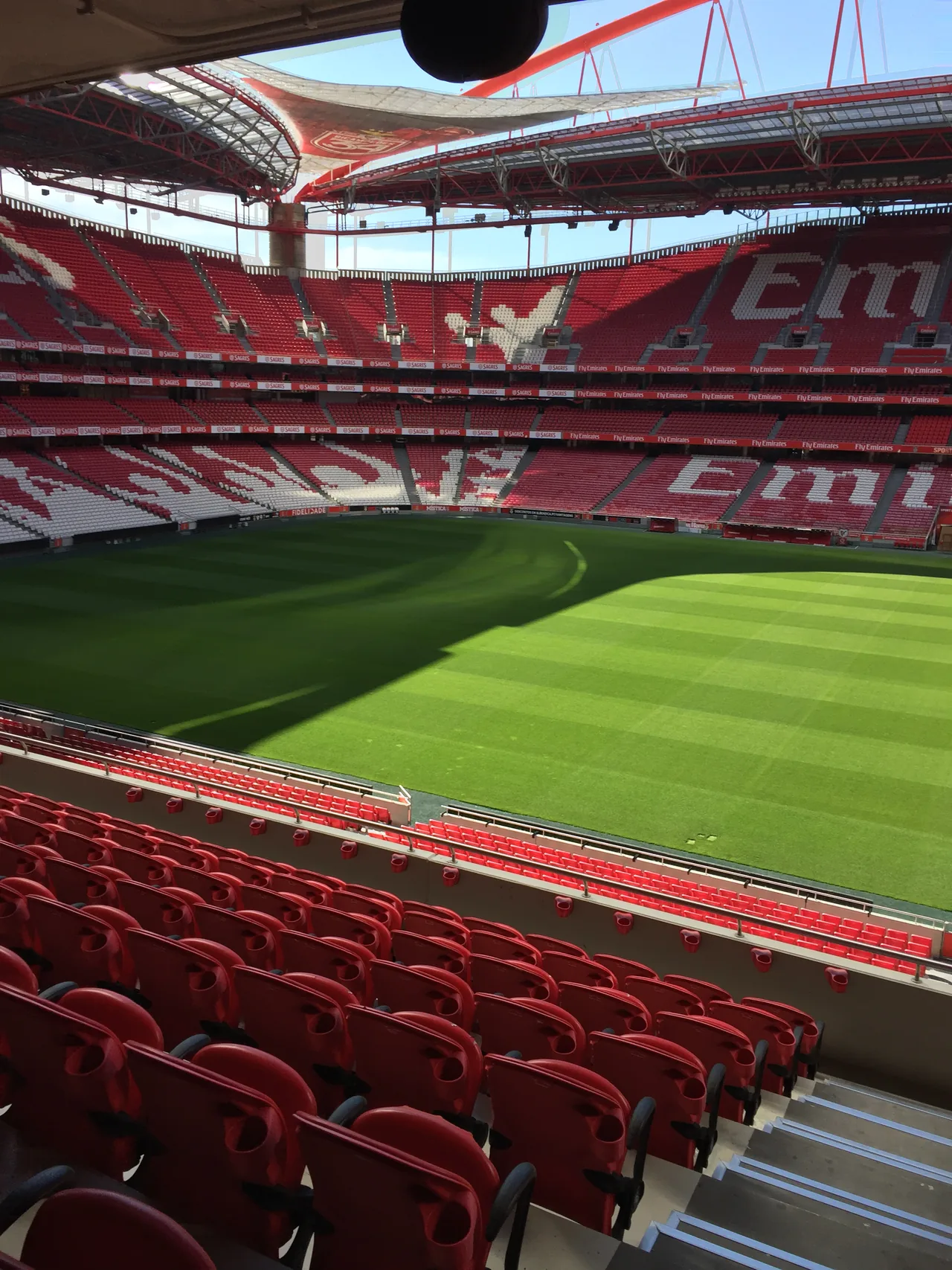 Rows of red seats overlooking the pitch at Estádio da Luz.