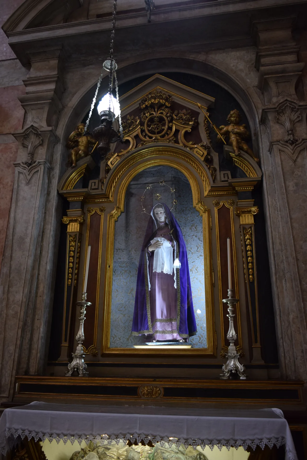 Gilded framing and a devotional image in a side chapel at St Anthony’s Church