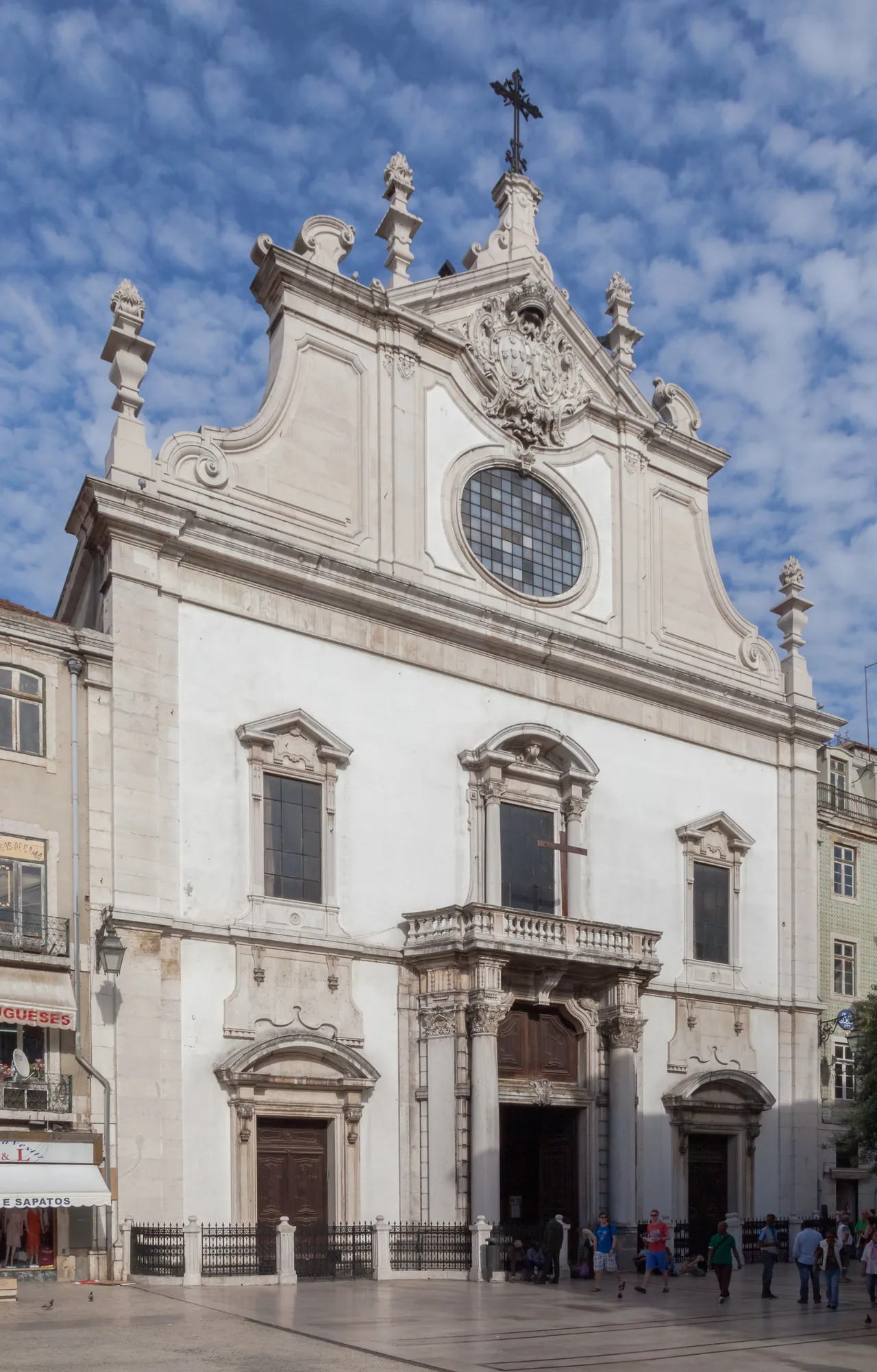 Fachada clara y portada esculpida de la iglesia de São Domingos bajo un cielo azul