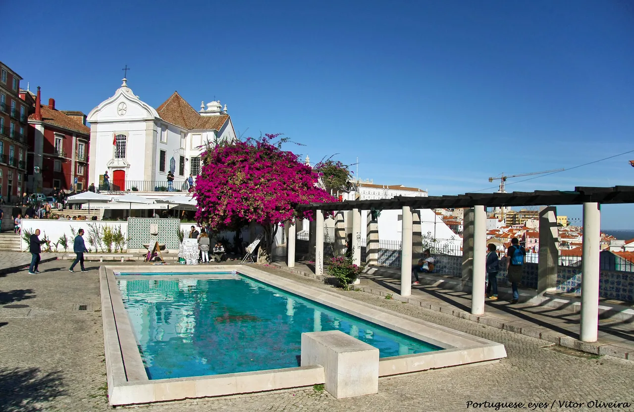 The garden pool, flowering pergola and church at the Santa Luzia viewpoint.