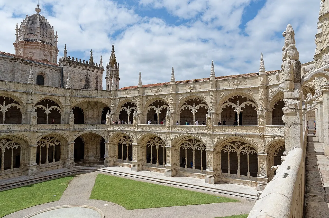 Two levels of richly carved arches around the cloister at Jerónimos Monastery.