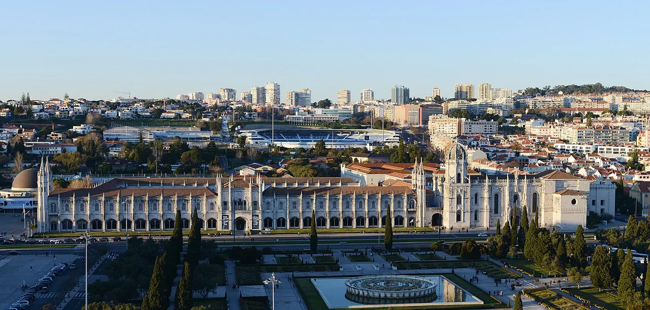 Jerónimos Monastery’s long façade and church beyond the gardens of Praça do Império.