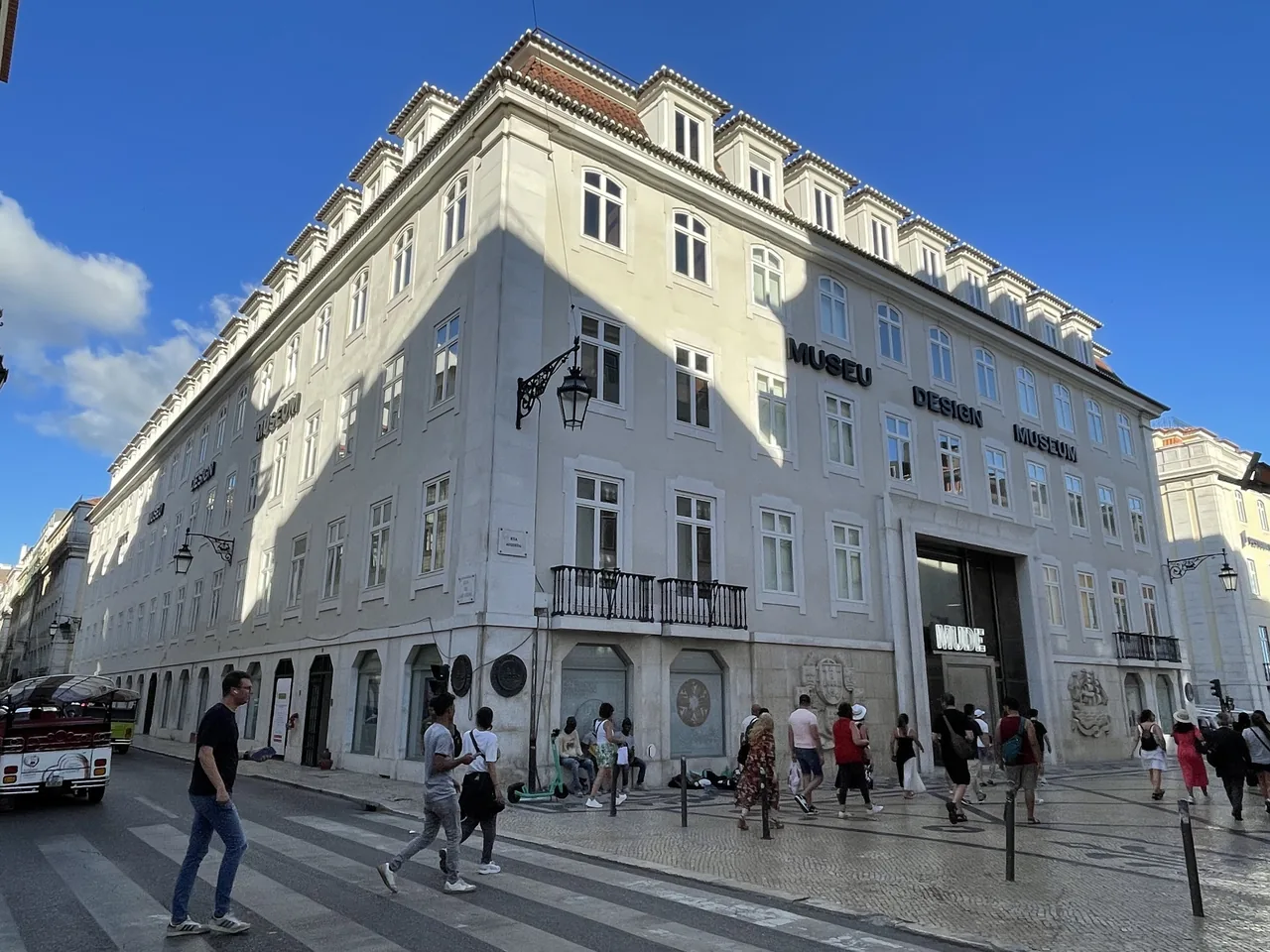 Restored white corner façade of MUDE on Rua Augusta
