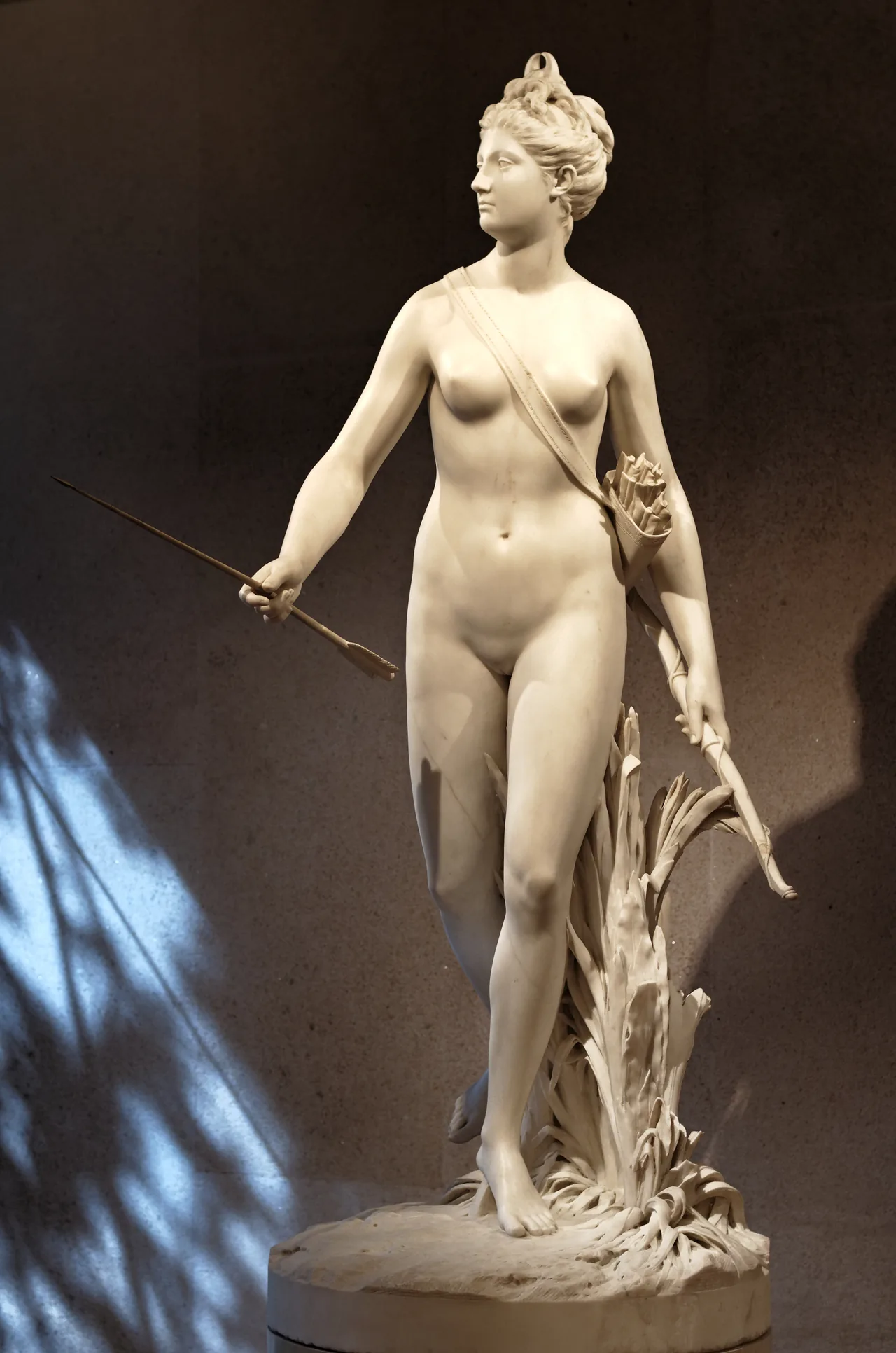 Houdon's marble statue of Diana with a bow, her body poised in movement.