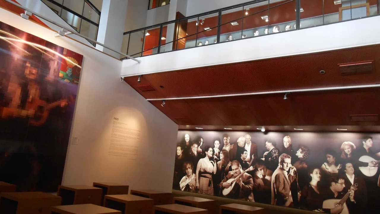 Two levels of the Fado Museum with a large montage of performers’ portraits