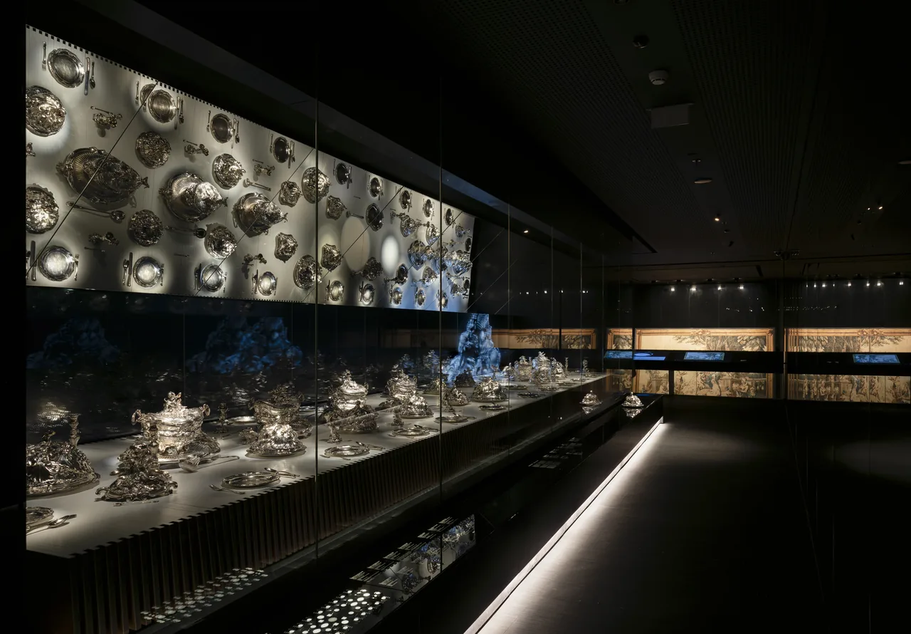 François-Thomas Germain’s silver table service arranged in a long illuminated museum display