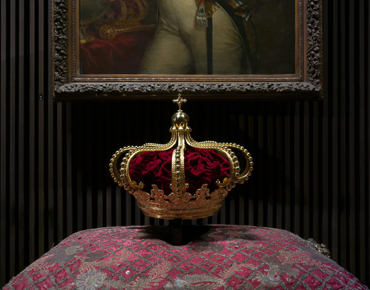 Gold royal crown with red lining displayed in the Royal Treasure Museum