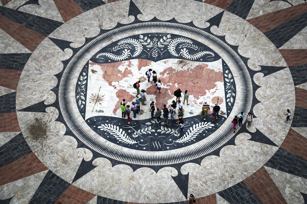The coloured world map and decorative sea creatures in the pavement beside the Monument to the Discoveries.