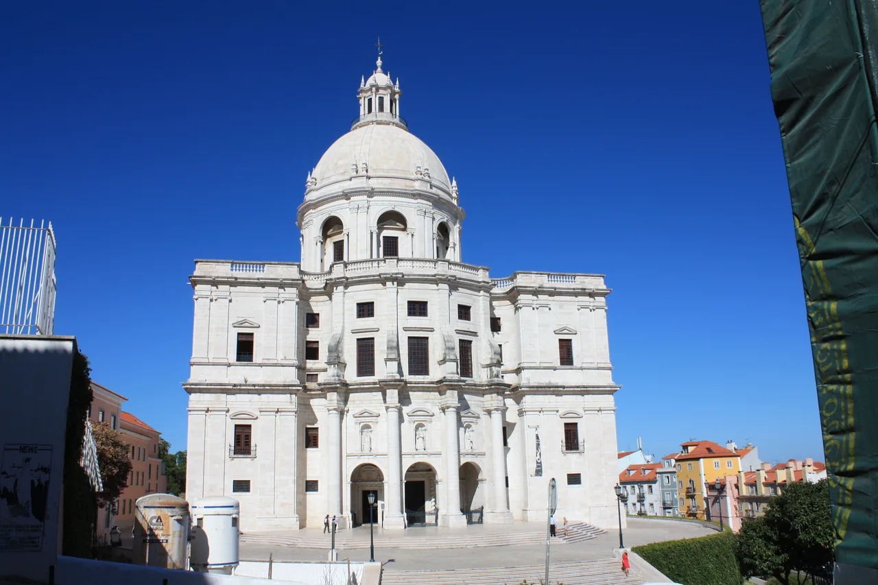 The white façade and dome of the National Pantheon against a blue sky.