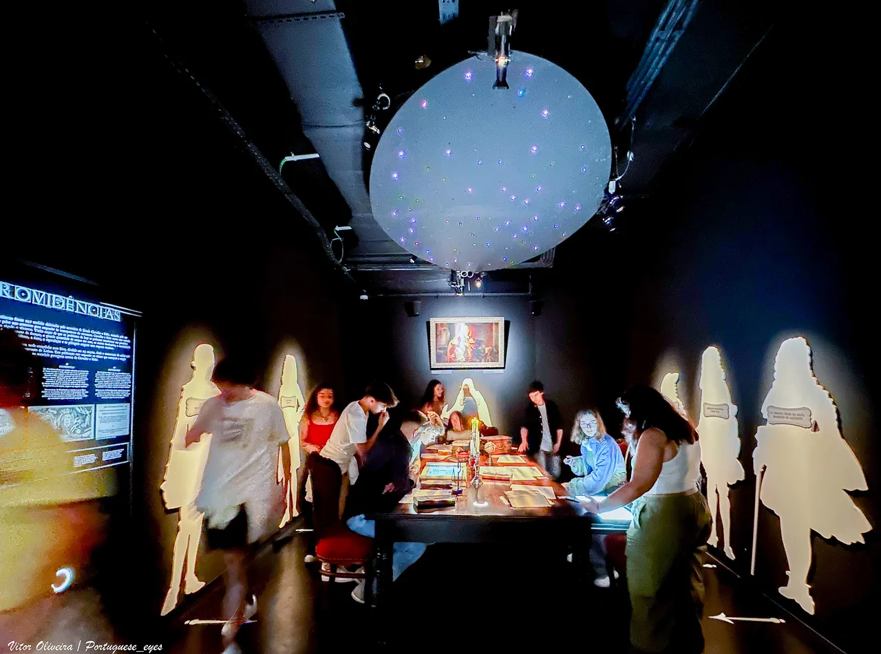 Visitors around an interactive table beneath a globe in Lisbon’s Quake museum.