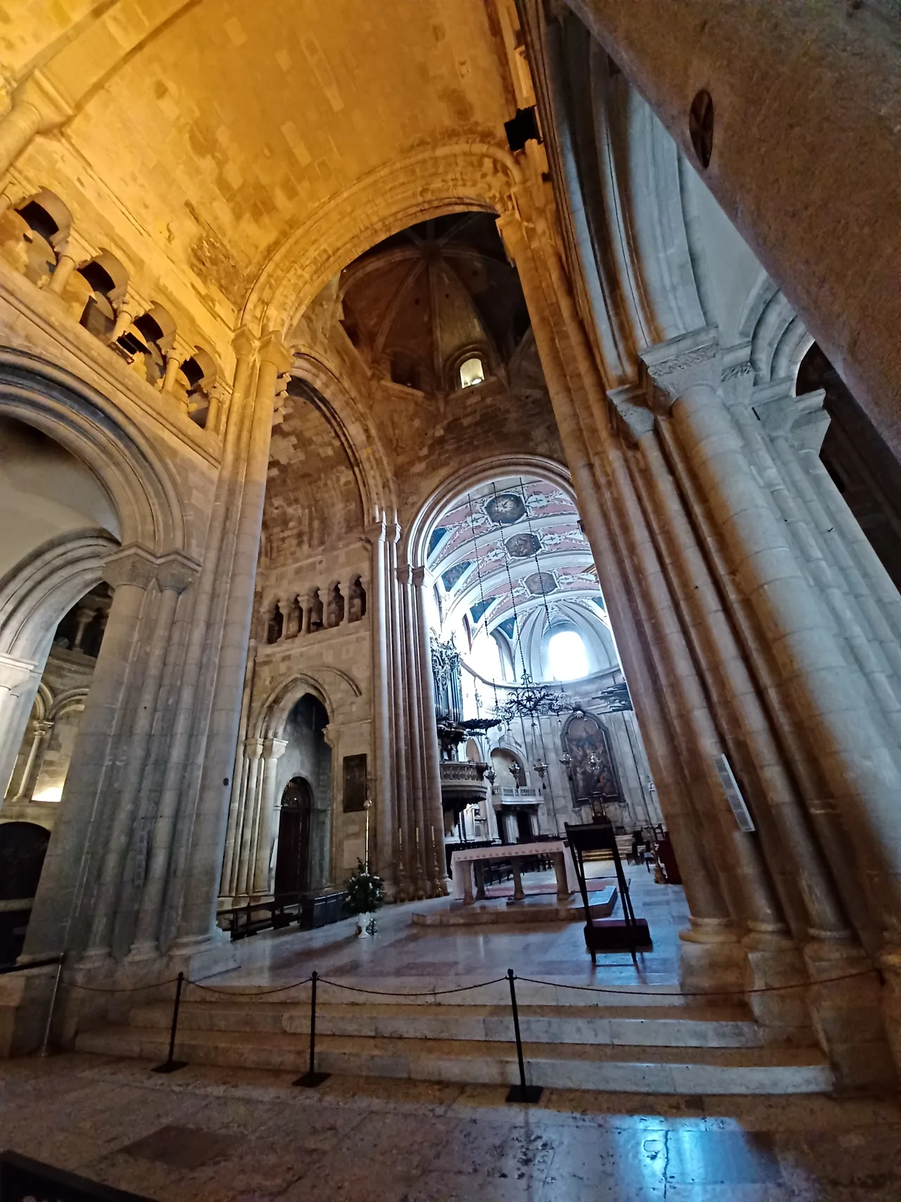 Tall stone arches and the vaulted interior of Lisbon Cathedral.