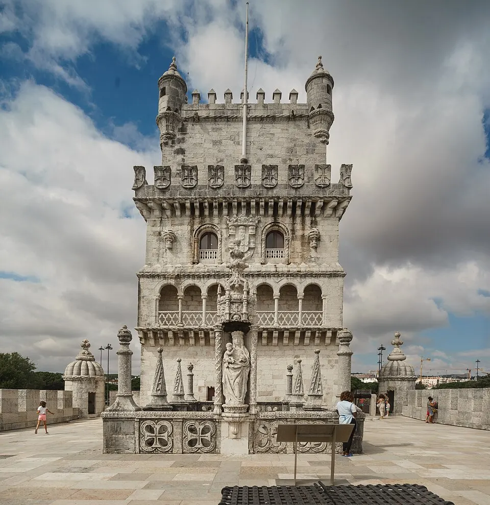 Belém Tower’s river-facing façade, carved balconies and statue on the bastion terrace.