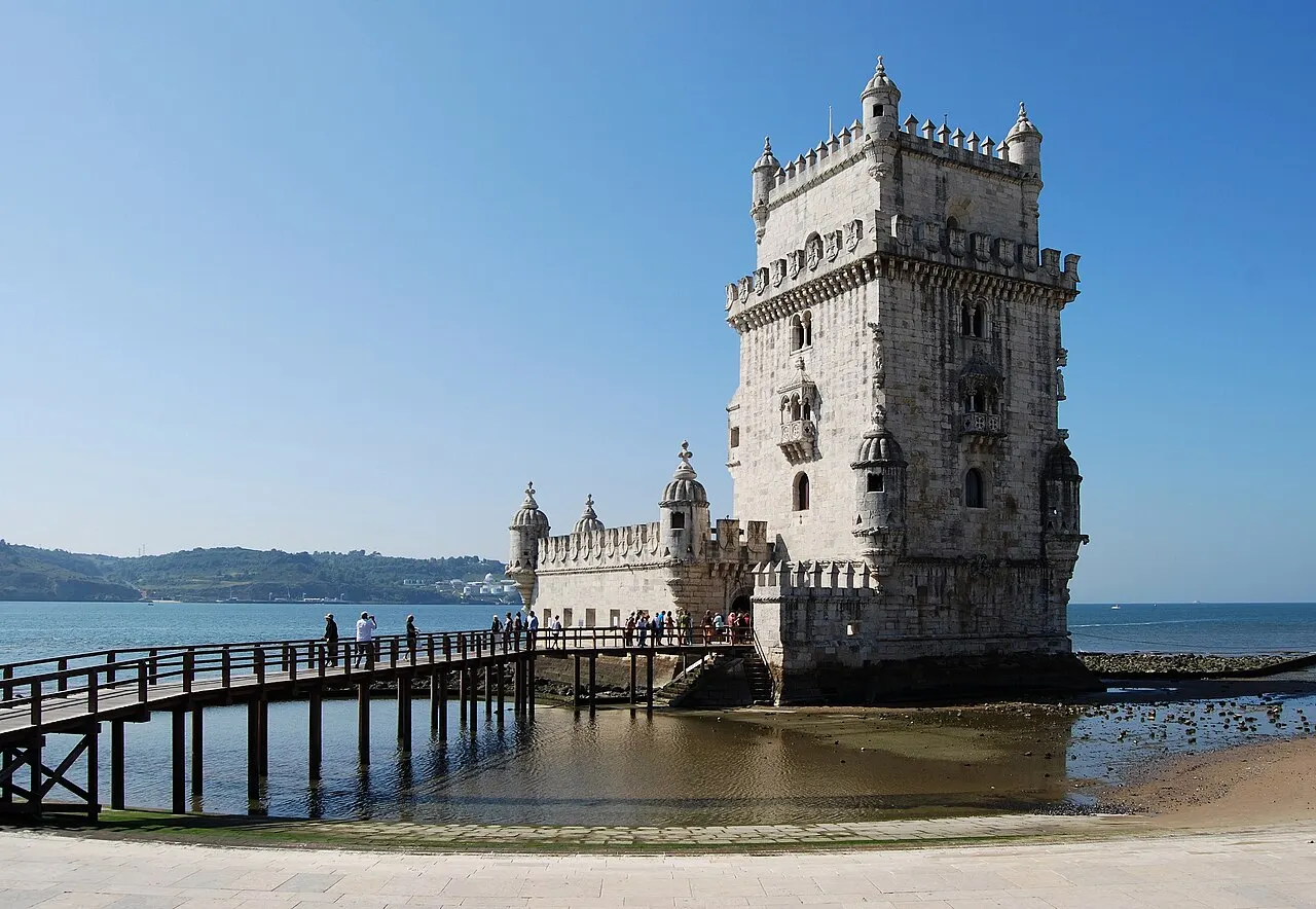 Belém Tower beside the Tagus, with its footbridge and low bastion visible.